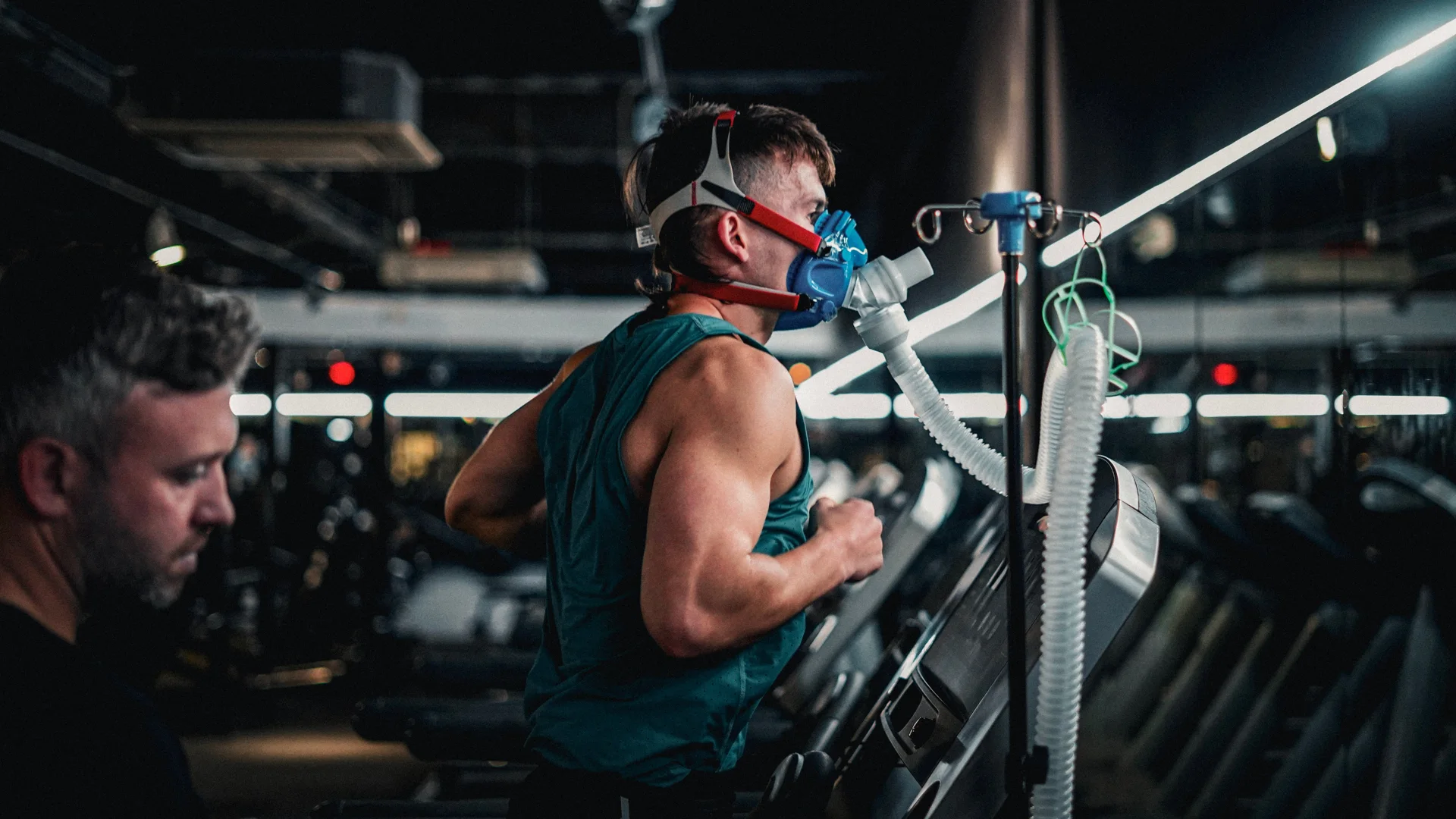 A client mid VO2 Max test on the treadmill with a TELOMYX specialist monitoring